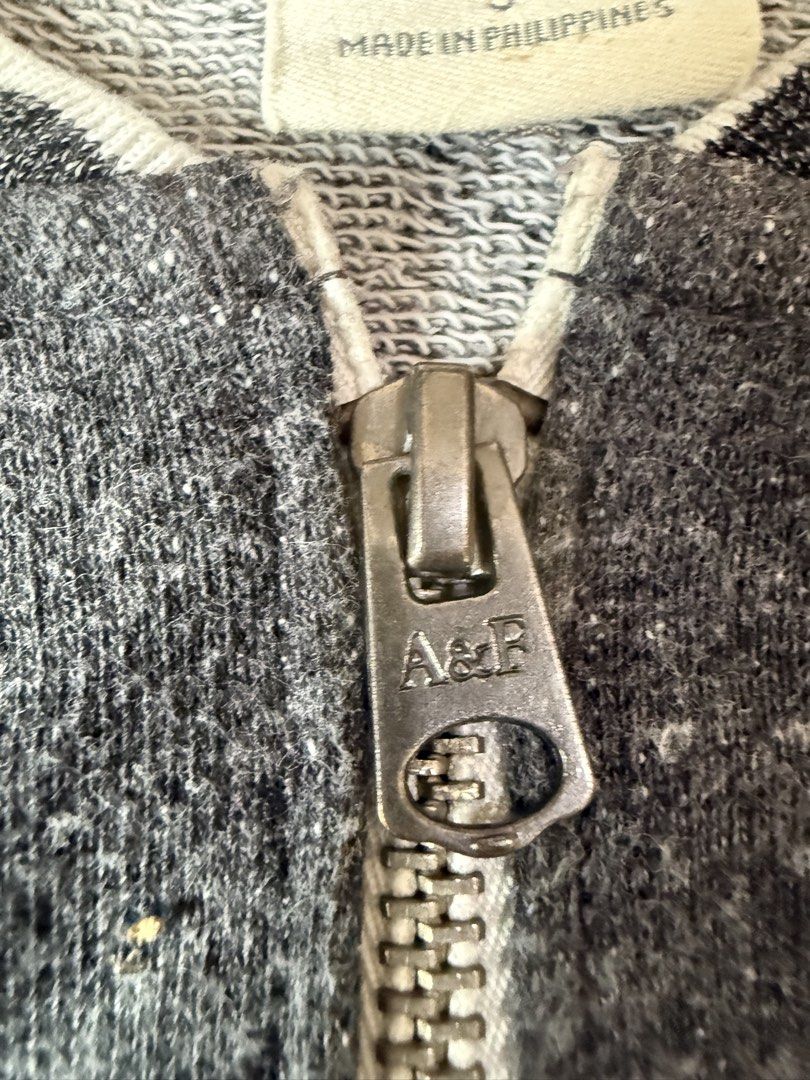 Abercrombie & Fitch Dark Grey Bomber Jacket Size S (Category: Coats, Jackets and Outerwear) located in Pasig City. Submitted by reese2022 (Listing ID 1470252053, Image 3). Description: Abercrombie & Fitch zip-up jacket in dark grey heather. Striped ribbed collar, cuffs, and hem in white and black. Two front welt pockets. Full metal zipper with A&F branding on the pull. .