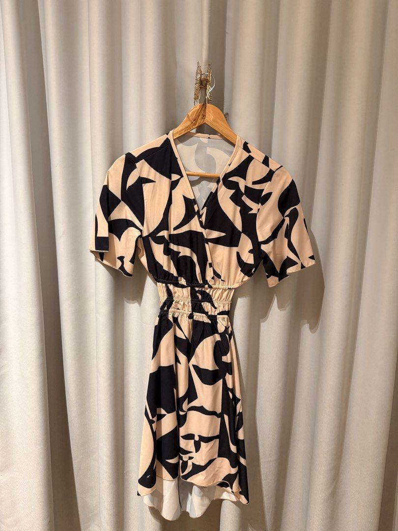 Abstract Print Pattern Cutout V-Neck Dress (Category: Dresses) located in Makati City. Submitted by regalbbb (Listing ID 1470218618, Image 1). Description: Original Price: Around 380 RFS: Decluttering Condition: Used twice but no flaws. Shein sizes run big so xs is really more small. - Design: Black and nude abstract geometric pattern - Style: V-neck wrap front with short sleeves - Details: Smocked elastic waist, trendy side cutouts, and open bac