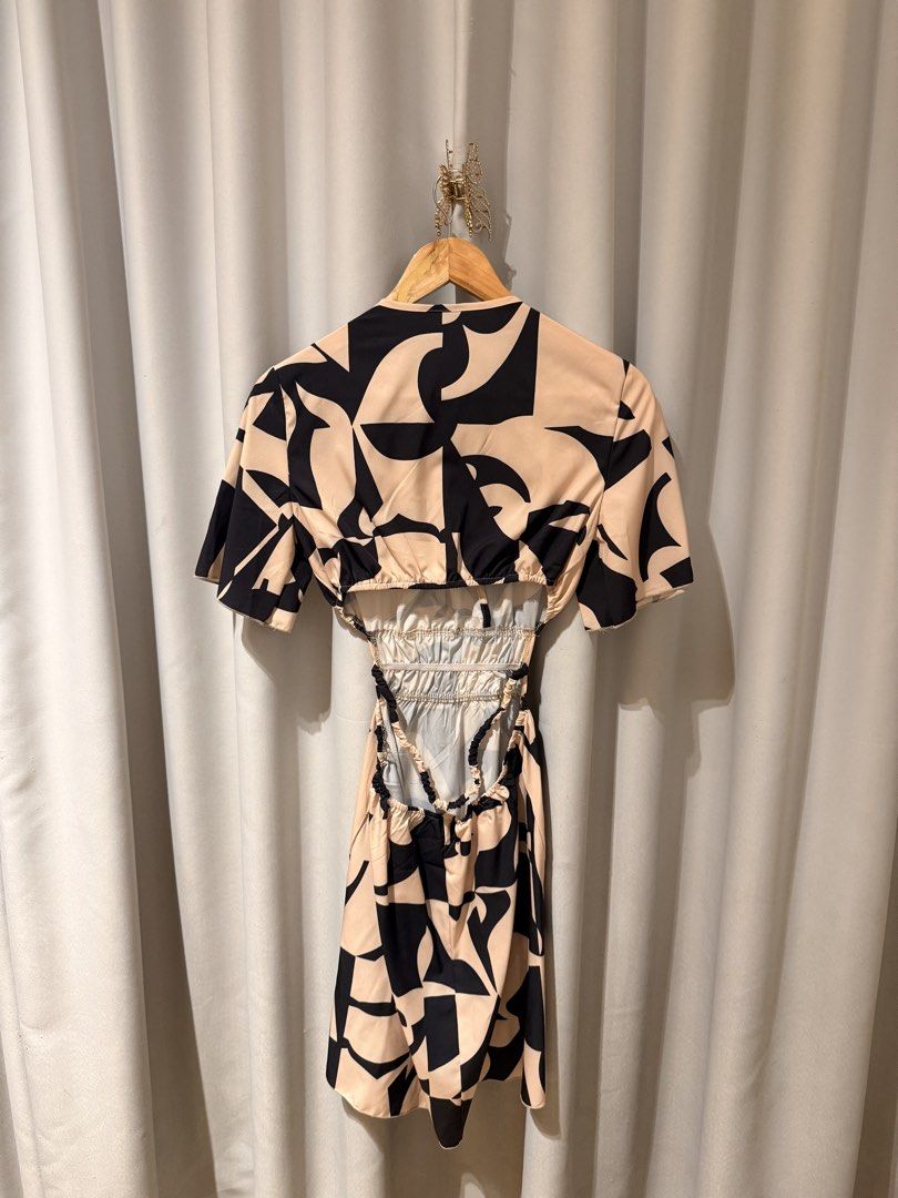 Abstract Print Pattern Cutout V-Neck Dress (Category: Dresses) located in Makati City. Submitted by regalbbb (Listing ID 1470218618, Image 2). Description: Original Price: Around 380 RFS: Decluttering Condition: Used twice but no flaws. Shein sizes run big so xs is really more small. - Design: Black and nude abstract geometric pattern - Style: V-neck wrap front with short sleeves - Details: Smocked elastic waist, trendy side cutouts, and open bac