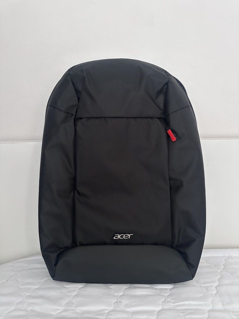 Acer Black Laptop Backpack with Red Accents (Category: Backpacks) located in Taguig. Submitted by tropicana1 (Listing ID 1470307631, Image 1). Description: - Brand: Acer - Color: Black with stylish red zipper pulls and interior trim - Laptop Compartment: Includes a secure strap for safety - Comfort: Padded shoulder straps and breathable mesh back panel - Organization: Multiple smaller interior compartments for easy storage - Durability: Solid bot