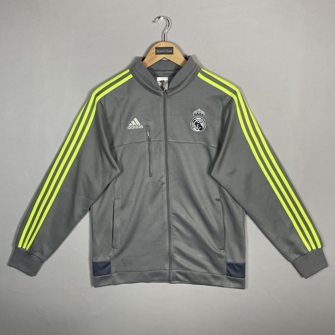 ADIDAS | Grey Real Madrid Full-Zip Track Jacket (Category: Coats, Jackets and Outerwear) located in Norzagaray. Submitted by sevenjscloset (Listing ID 1470260798, Image 1). Description: - Authentic Adidas Real Madrid full-zip track jacket - Color: Grey with striking neon yellow three stripes - Size: Medium on tag (Actual measurements: Length 26", Width 19.5") - Features club crest on chest and handy zip chest pocket - Model reference: 5'10" and 7