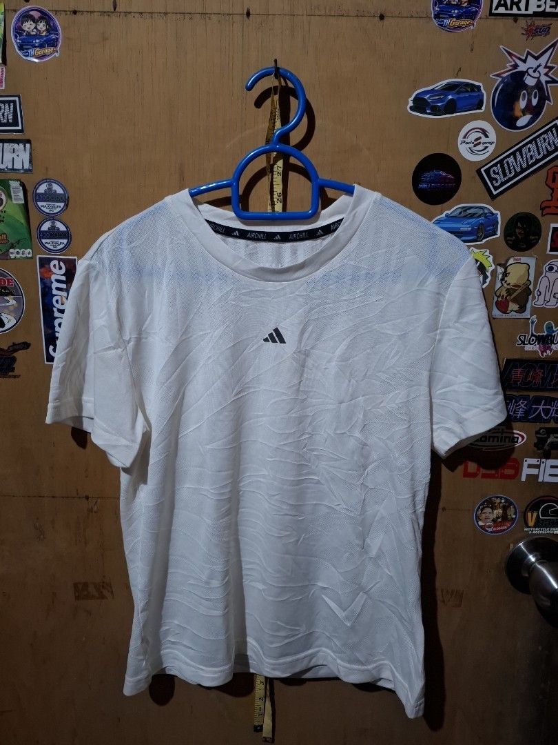 Adidas Aichill White T-shirt (Category: Shirts) located in Victorias. Submitted by doc_keith (Listing ID 1470297940, Image 1). Description: Brand: Adidas Aichill -size:small (17x21.5) Color: White - Style: Short sleeve top, standard fit Fabric: Breathable, lightweight textured material with a subtle wavy pattern Details: Center chest logo and signature Aichill collar tape Condition: Clean and well-maintained - Versatility: Ideal for training or c