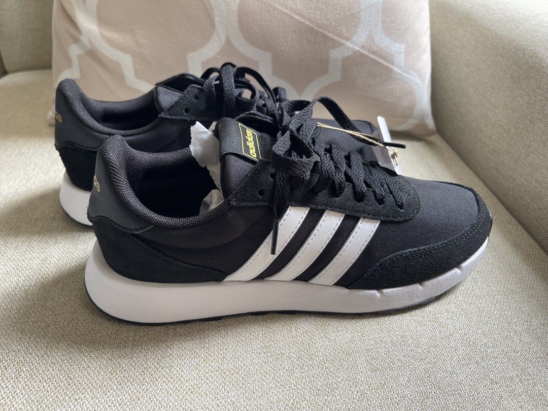 Adidas Black and White Sneakers (Category: Sneakers) located in Butuan. Submitted by anneven14 (Listing ID 1470292239, Image 2). Description: last price: 1,400- Brand: Adidas - Color: Black with white stripes and gold branding - Condition: Brand new with original tags attached - Features: Traditional lace-up closure, thick white midsole, and textured black rubber outsole - Extras: Original packing paper still stuffed inside to maintain shape.