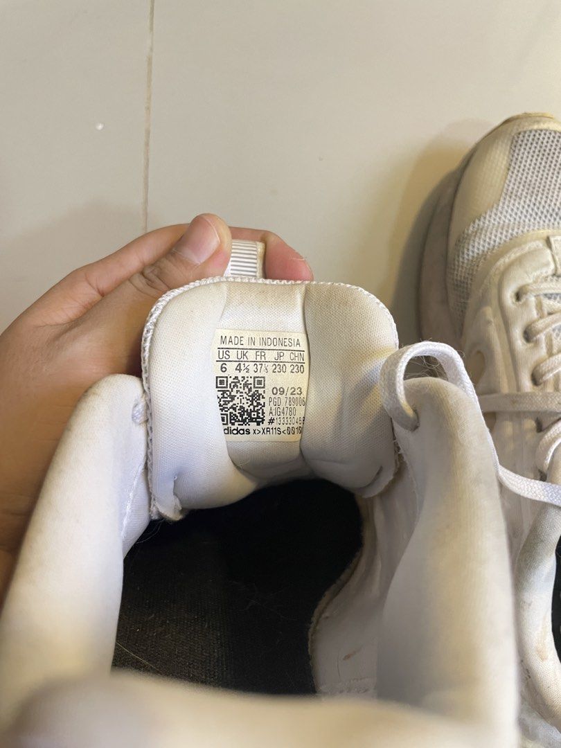 Adidas Boost White Running Shoes (Category: Sneakers) located in Los Banos. Submitted by reinabee88 (Listing ID 1470234610, Image 3). Description: - Brand: Adidas Boost - Color: Classic White - Material: Breathable mesh upper with chunky sole and iconic three-stripe branding - Condition: Used / Pre-loved, no tears/holes, just noticeable yellowing on the midsoles and minor scuff marks on the uppers and heels - Used less than 10 times, sole is inta