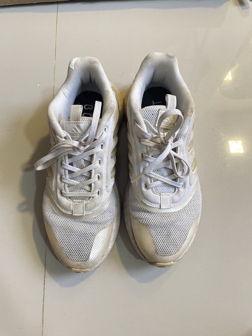 Adidas Boost White Running Shoes (Category: Sneakers) located in Los Banos. Submitted by reinabee88 (Listing ID 1470234610, Image 1). Description: - Brand: Adidas Boost - Color: Classic White - Material: Breathable mesh upper with chunky sole and iconic three-stripe branding - Condition: Used / Pre-loved, no tears/holes, just noticeable yellowing on the midsoles and minor scuff marks on the uppers and heels - Used less than 10 times, sole is inta