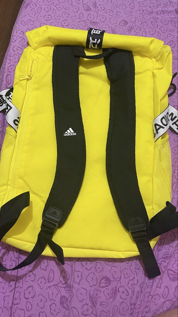 Adidas Bright Yellow Backpack with Black Straps (Category: Backpacks) located in Quezon City. Submitted by timmytheninja (Listing ID 1470161011, Image 2). Description: - Vibrant yellow Adidas backpack with striking black straps and bold branding - Durable fabric material with secure zipper closure and clean yellow zipper pull - Convenient mesh side pockets on both sides for water bottles or essentials - Adjustable shoulder straps featuring the ic