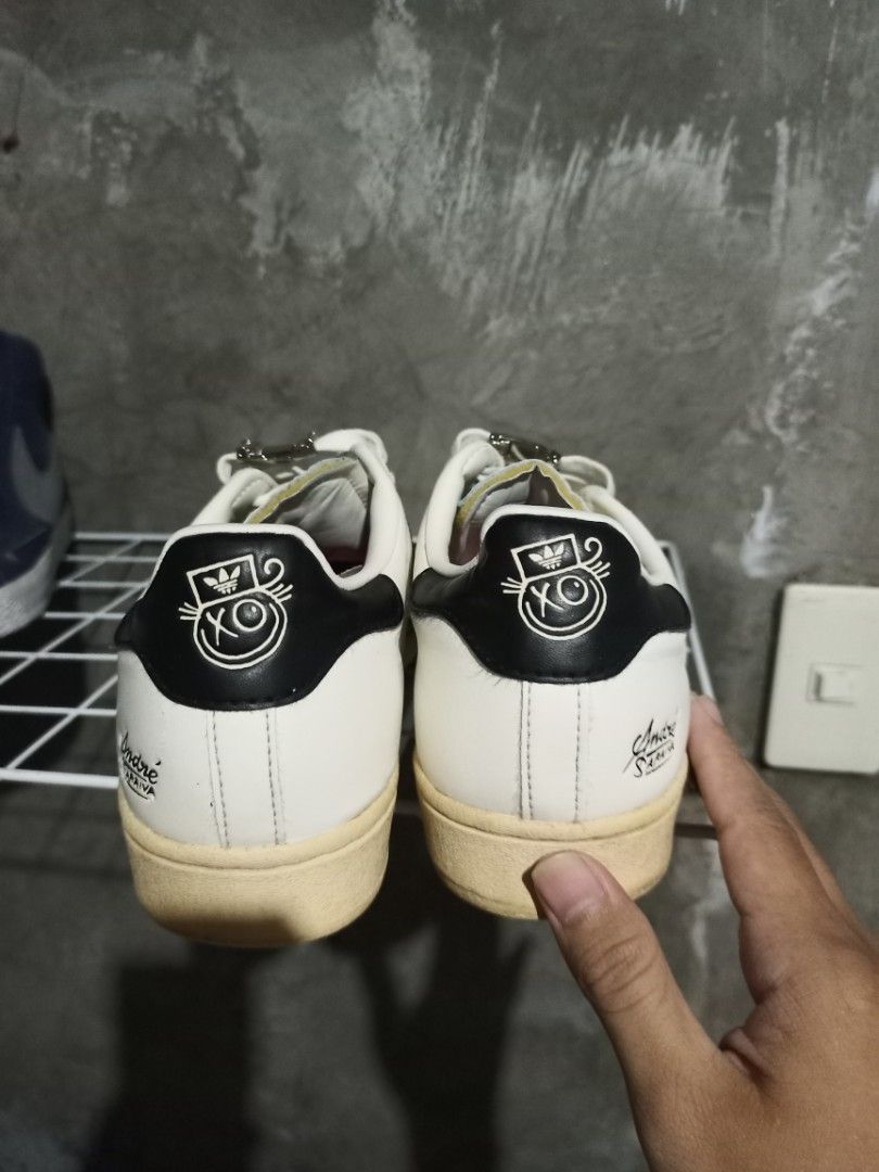 Adidas Superstar x Andre Saraiva White Black (Category: Sneakers) located in Mabalacat. Submitted by hasashoe (Listing ID 1470283786, Image 3). Description: - Brand: Adidas x André Saraiva Superstar - Color: White leather with black stripes and heel tab - Distinctive Details: Signature Mr. A cartoon graphics on heel and tongue, plus playful pink insoles - Size: US 8.5 / UK 8 / FR 42 - Condition: Yellowed midsoles for an authentic vintage look, so