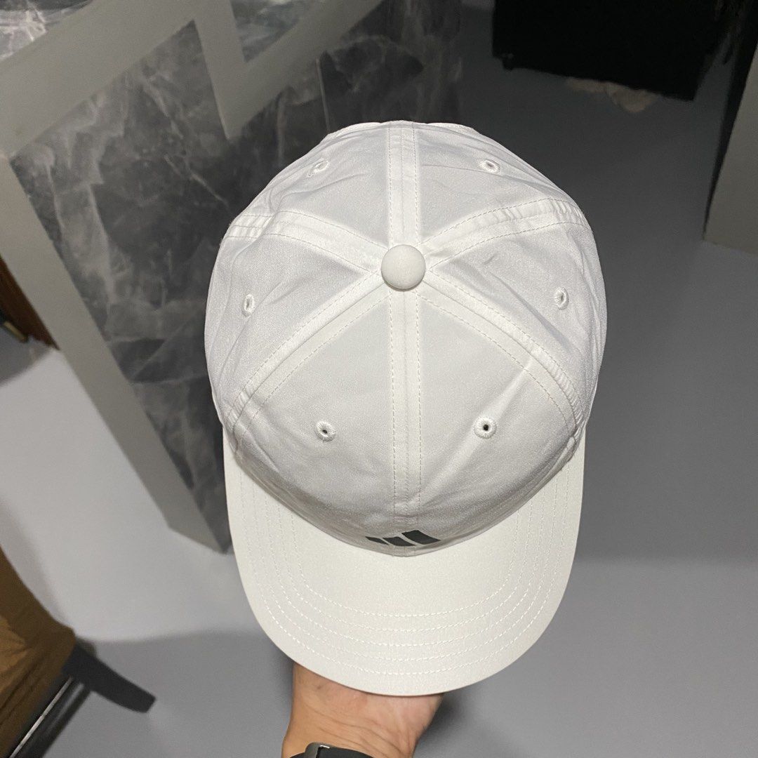 Adidas White Aeroready Baseball Cap (Category: Caps & Hats) located in Villasis. Submitted by thriftngrind (Listing ID 1470286816, Image 2). Description: - Authentic white Adidas cap - AEROREADY technology inside keeps sweat away - Classic black logo on the front - Clean white panels with eyelets for breathability - Standard six-panel construction - Adjustable metal strap closure with embossed logo hardware - Great everyday accessory for workouts
