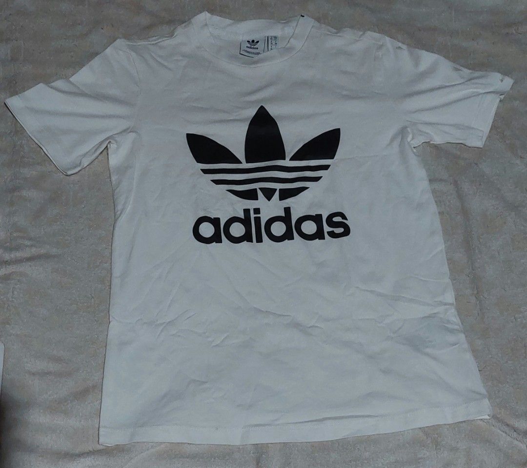 Adidas white tee (Category: Tshirts & Polo Shirts ) located in Daet. Submitted by stonervoid (Listing ID 1470275729, Image 1). Description: Adidas white tee 17x24 300 shipped.