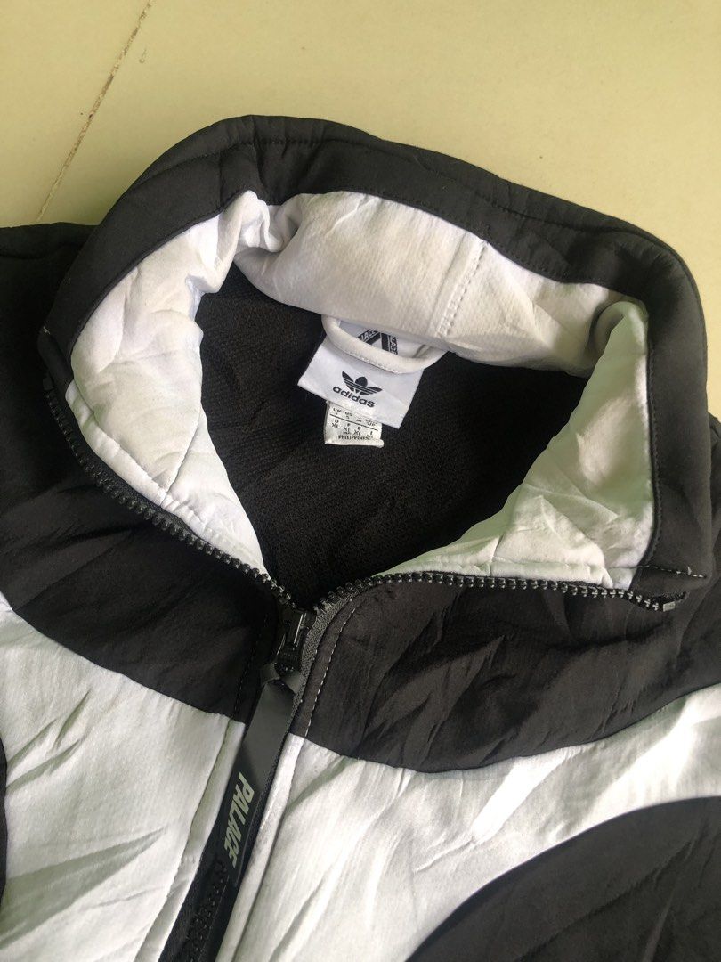 Adidas x Palace Half Zip Track Jacket (Category: Coats, Jackets and Outerwear) located in Cagayan de Oro. Submitted by leklekthrift (Listing ID 1470259472, Image 2). Description: - Brand: Adidas x Palace - Style: Half-zip track jacket in black and white colourblock - Details: High collar with large PALACE branding on the back, custom Palace zip pull - Accents: Classic three stripes on sleeves, dual side zip pockets - Sizing: UK/US Size S (D/F/E/I