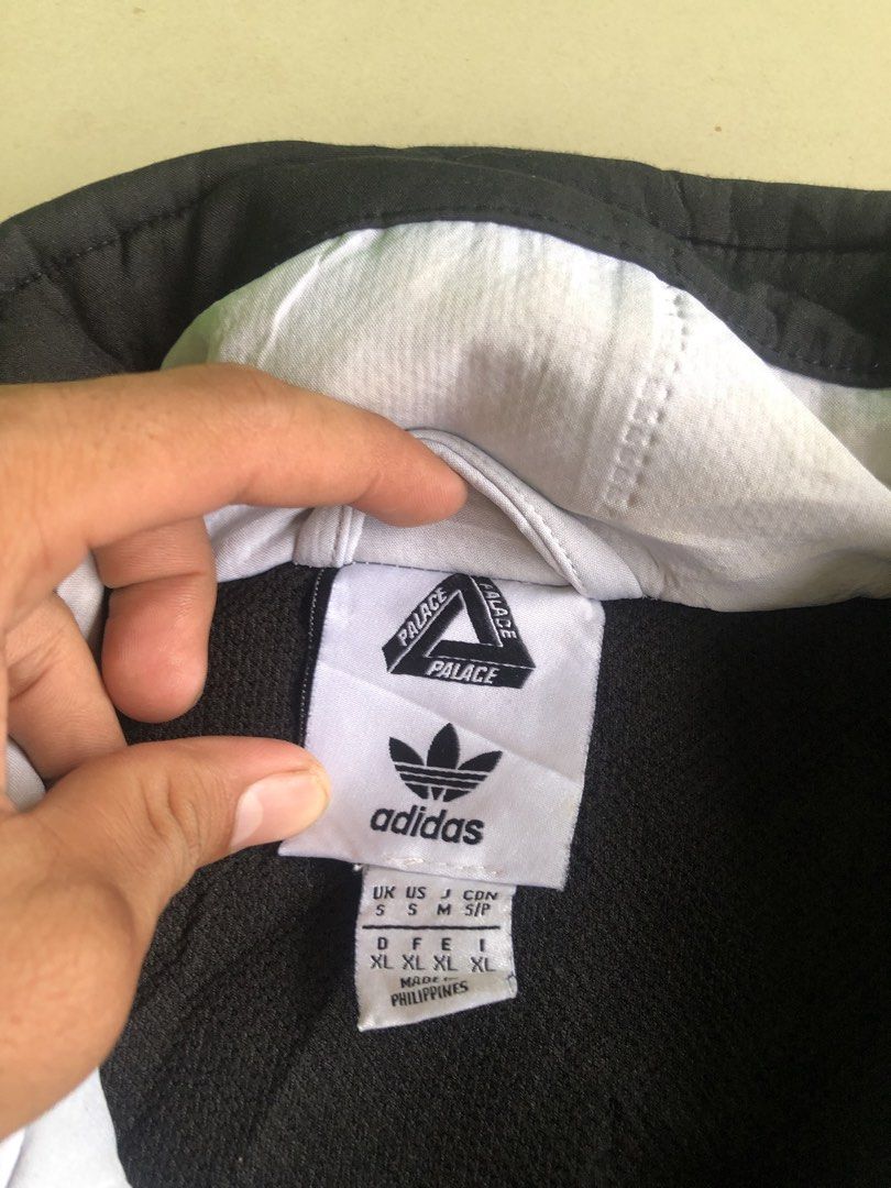 Adidas x Palace Half Zip Track Jacket (Category: Coats, Jackets and Outerwear) located in Cagayan de Oro. Submitted by leklekthrift (Listing ID 1470259472, Image 3). Description: - Brand: Adidas x Palace - Style: Half-zip track jacket in black and white colourblock - Details: High collar with large PALACE branding on the back, custom Palace zip pull - Accents: Classic three stripes on sleeves, dual side zip pockets - Sizing: UK/US Size S (D/F/E/I