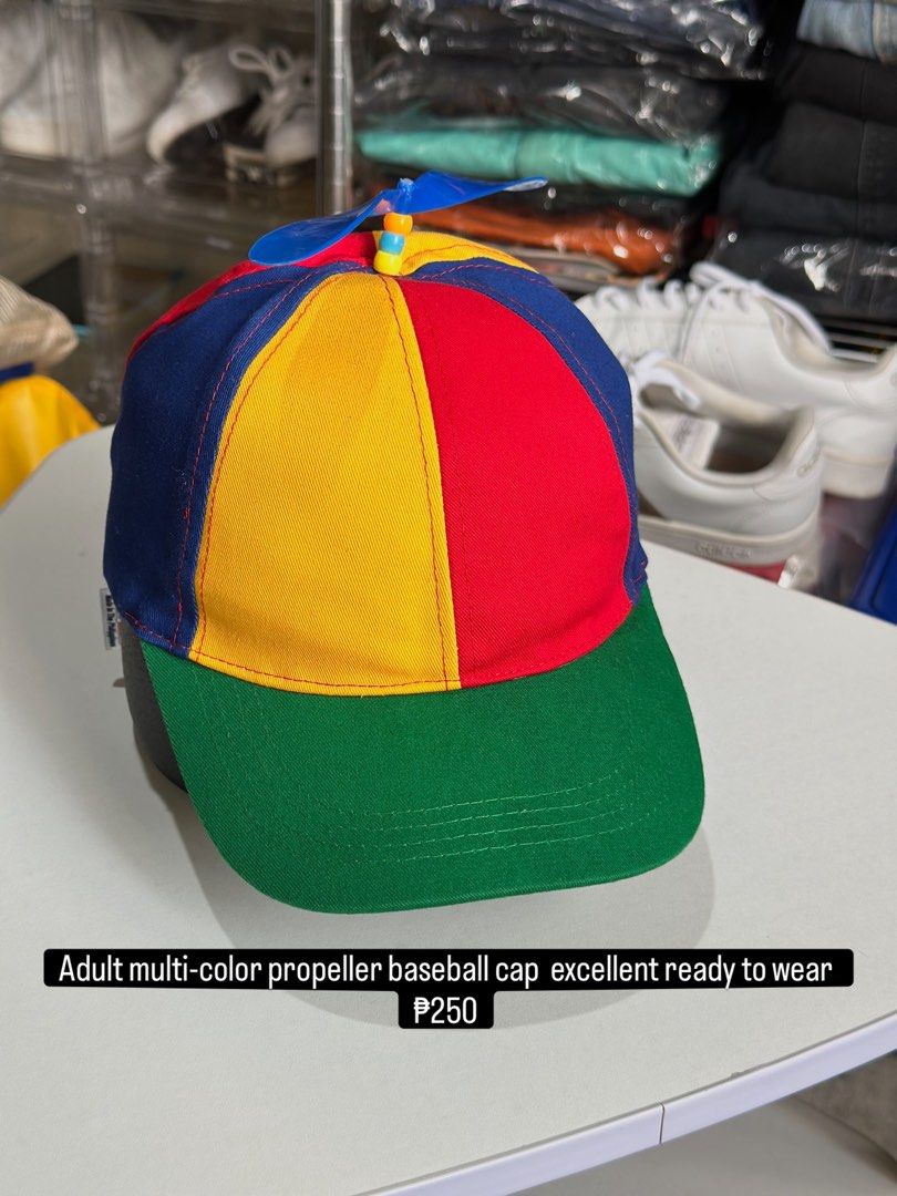 Adult multi-color propeller baseball cap (Category: Caps & Hats) located in Daet. Submitted by thrifthings2018 (Listing ID 1470195135, Image 1). Description: - Vibrant multi-color design featuring red, yellow, blue, and green panels - Adorned with a playful blue propeller on top - Adjustable back strap for a customizable fit - Ideal novelty accessory for costume parties, events, or casual fun - Brand new and ready to wear.