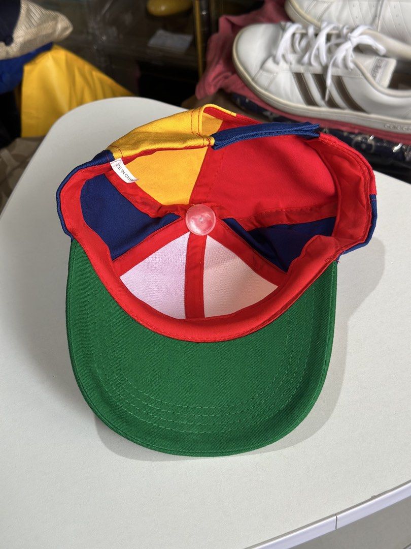 Adult multi-color propeller baseball cap (Category: Caps & Hats) located in Daet. Submitted by thrifthings2018 (Listing ID 1470195135, Image 2). Description: - Vibrant multi-color design featuring red, yellow, blue, and green panels - Adorned with a playful blue propeller on top - Adjustable back strap for a customizable fit - Ideal novelty accessory for costume parties, events, or casual fun - Brand new and ready to wear.