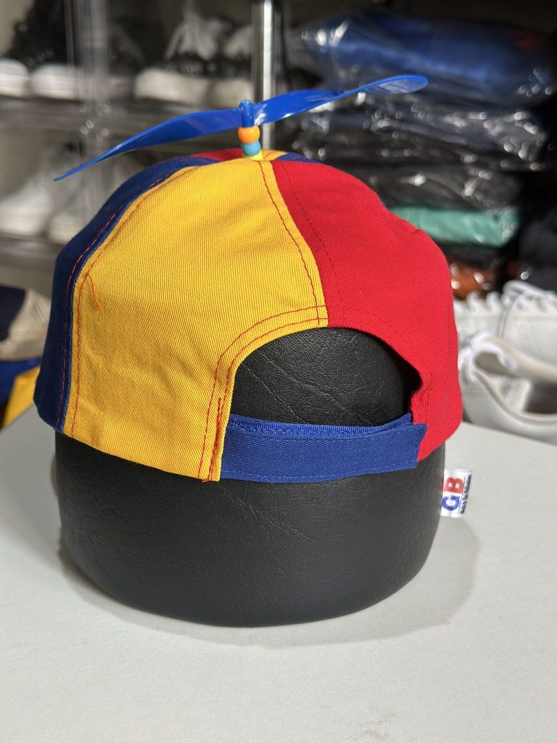 Adult multi-color propeller baseball cap (Category: Caps & Hats) located in Daet. Submitted by thrifthings2018 (Listing ID 1470195135, Image 3). Description: - Vibrant multi-color design featuring red, yellow, blue, and green panels - Adorned with a playful blue propeller on top - Adjustable back strap for a customizable fit - Ideal novelty accessory for costume parties, events, or casual fun - Brand new and ready to wear.