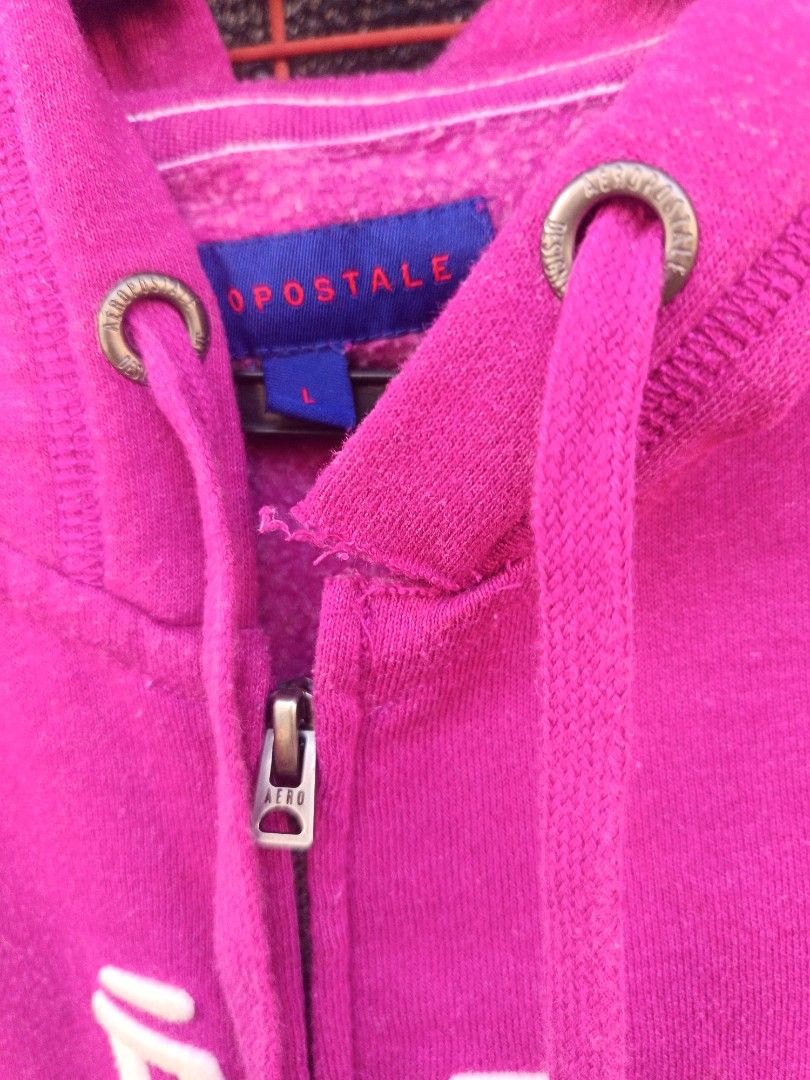 Aero hoodie (Category: Coats, Jackets and Outerwear) located in Aroroy. Submitted by vin2za06 (Listing ID 1470348304, Image 3). Description: This is a fuchsia pink Aéropostale full-zip hoodie featuring the classic stacked brand logo ("Aéro / postale / New York") printed across the chest..
