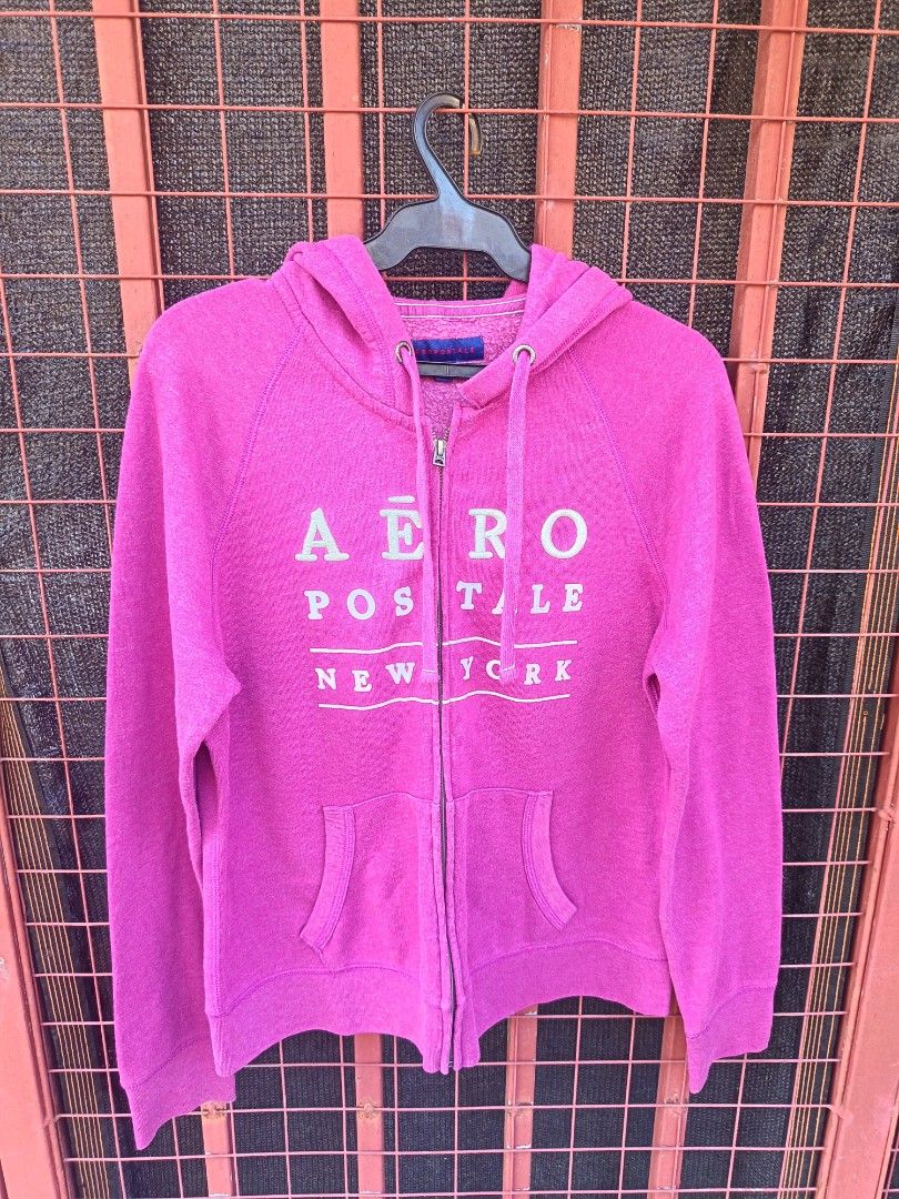 Aero hoodie (Category: Coats, Jackets and Outerwear) located in Aroroy. Submitted by vin2za06 (Listing ID 1470348304, Image 1). Description: This is a fuchsia pink Aéropostale full-zip hoodie featuring the classic stacked brand logo ("Aéro / postale / New York") printed across the chest..