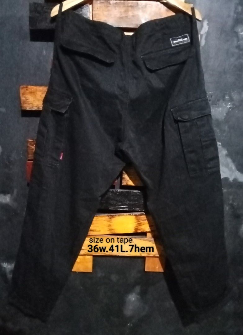 AFFD Brotherhood Black Cargo Pants Size 36 (Category: Jeans) located in Caloocan City. Submitted by calmcat_6fd4f7 (Listing ID 1470345472, Image 2). Description: - Brand: AFFD Brotherhood - Style: Black cargo pants in solid dark wash denim - Storage: Multiple utility pockets on the sides and back - Details: Branded patch sewn above the right back pocket - Waist: 36 inches - Length: 41 inches - Hem: 7 inches.