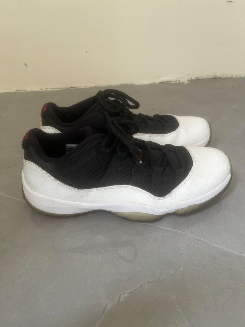 Air Jordan 11 Retro Low Tuxedo (Category: Sneakers) located in Bulacan. Submitted by jhemieee (Listing ID 1470191582, Image 2). Description: - Model: Air Jordan 11 Retro Low 'Concord' - Size: US 9 / UK 8 / EUR 42.5 - Design: Black mesh upper with iconic white patent leather mudguard and translucent outsole with red traction pods - Condition: Minor scuffs on the white patent leather and natural yellowing on the soles due to age and wear - Authenti