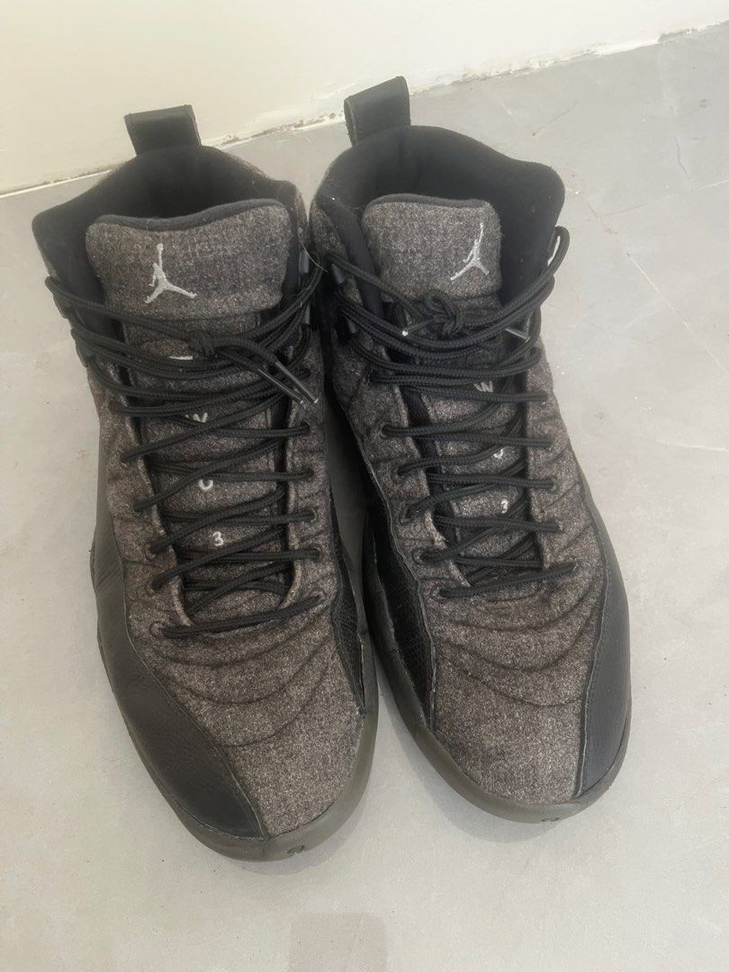 Air Jordan 12 Retro Wool Dark Grey (Category: Sneakers) located in Bulacan. Submitted by jhemieee (Listing ID 1470190468, Image 2). Description: - Model: Air Jordan 12 Retro - Colorway: Dark Grey Wool with Black Leather Mudguards - Size: US 10.5 - Condition: Clean soles with visible carbon fiber shank plates and original size tag - Features: Matching black laces, Jumpman logo on the tongue and heel pull tabs.