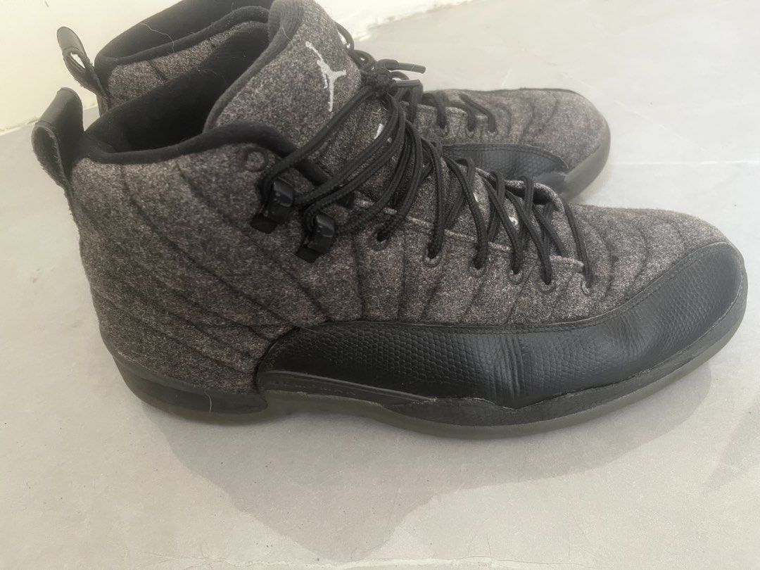 Air Jordan 12 Retro Wool Dark Grey (Category: Sneakers) located in Bulacan. Submitted by jhemieee (Listing ID 1470190468, Image 3). Description: - Model: Air Jordan 12 Retro - Colorway: Dark Grey Wool with Black Leather Mudguards - Size: US 10.5 - Condition: Clean soles with visible carbon fiber shank plates and original size tag - Features: Matching black laces, Jumpman logo on the tongue and heel pull tabs.