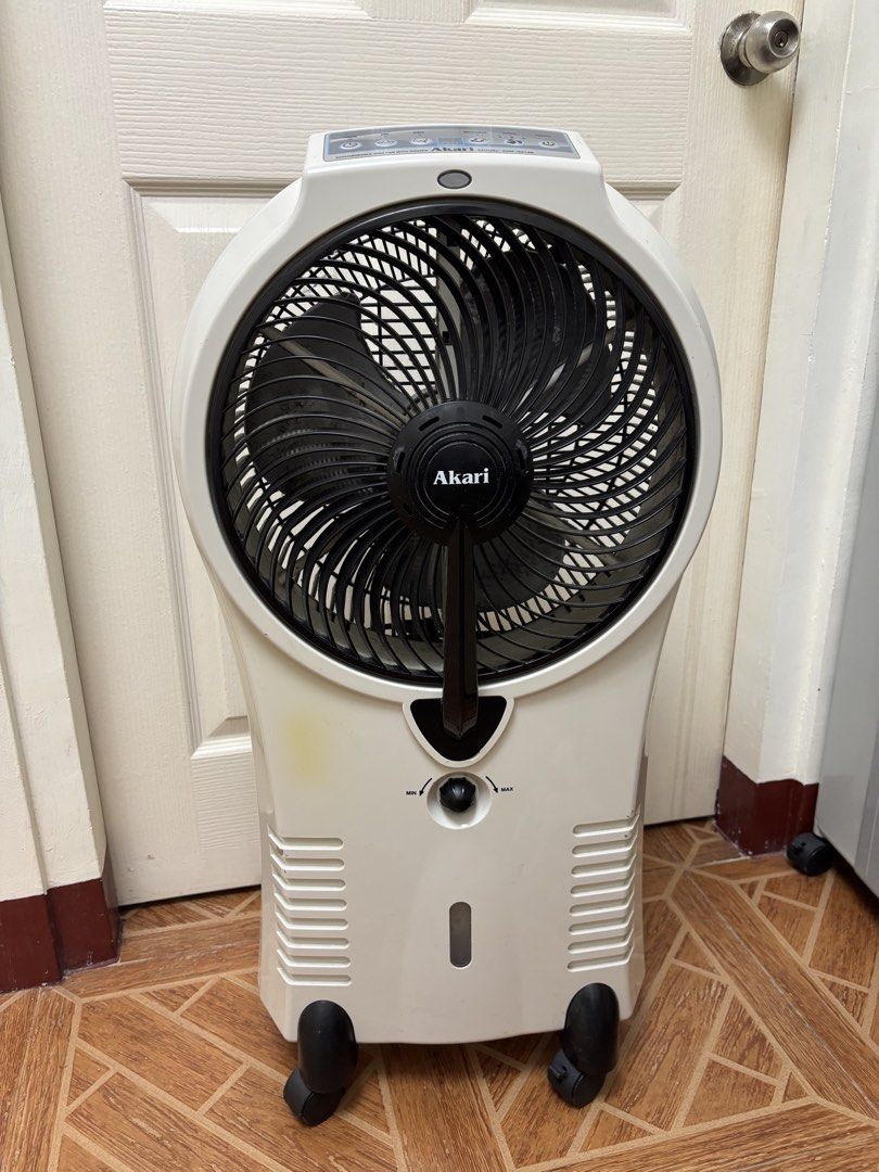 Akari Mist Fan AMP-33144 (Category: Fans) located in Paranaque City. Submitted by xavieraxb (Listing ID 1470170406, Image 1). Description: - Brand/Model: Akari Mist Fan (AMP-33144) - Color: White and grey - Mobility: Equipped with 4 castor wheels for easy moving - Features: Top control panel, front speed knob, back water tank, and power cord storage hooks - Power: Can be used plugged in - Condition: Dusty blades and light marks on the casing, but
