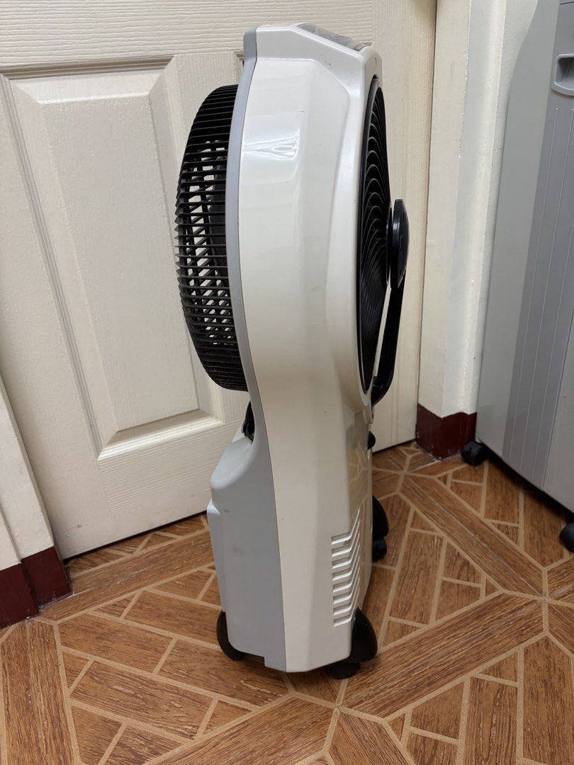 Akari Mist Fan AMP-33144 (Category: Fans) located in Paranaque City. Submitted by xavieraxb (Listing ID 1470170406, Image 2). Description: - Brand/Model: Akari Mist Fan (AMP-33144) - Color: White and grey - Mobility: Equipped with 4 castor wheels for easy moving - Features: Top control panel, front speed knob, back water tank, and power cord storage hooks - Power: Can be used plugged in - Condition: Dusty blades and light marks on the casing, but