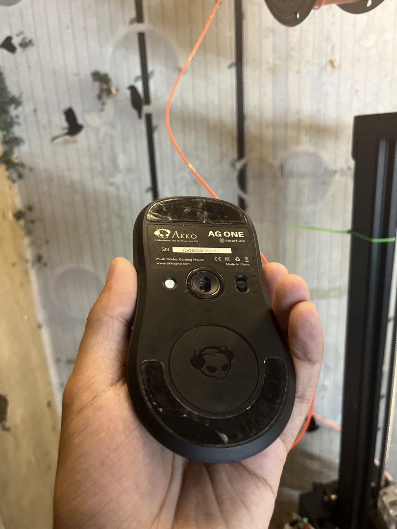 Akko AG One NearLink Multi-Modes Gaming Mouse (Category: Mouse & Mousepads) located in Quezon City. Submitted by alyxxz (Listing ID 1470145737, Image 2). Description: - Model: Akko AG One Gaming Mouse (Matte Black) - Connectivity: Multi-mode (2.4G wireless & Bluetooth) - Inclusions: USB receiver and magnetic puck - Condition: Sensor and switches work perfectly; clean matte body - Note: Scuffs and scratches on bottom glide feet from normal desk us