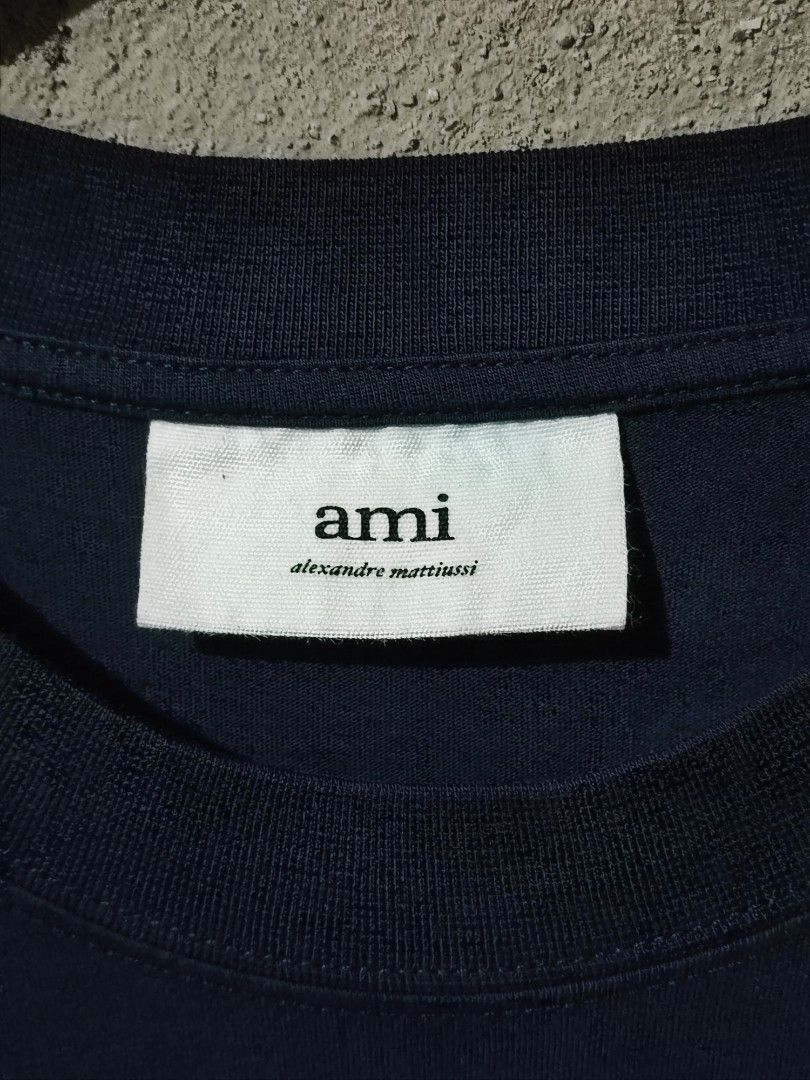 ALEXANDER MATTIUSSI 'AMI' SMALL HEART LOGO TEE (Category: Shirts) located in Iloilo. Submitted by gooddimes (Listing ID 1470216088, Image 3). Description: Alexander Mattiussi 'AMI' Small Heart Logo Tee Authentic Fresh from bale Embroidered Chest Logo Dark Blue color Size on tag: Large Dimes: 20.5x28L Issue/s: Sign of Usage Color rate: 9/10, Neckline 8.8/10 Good condition ₱1,499 +sf Reminders: - All items are thrifted, please manage your expectati