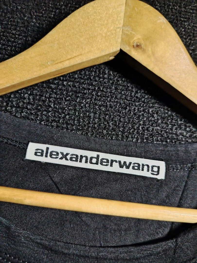 Alexander Wang Black Crop Tee with Pocket (Category: Shirts) located in Baguio. Submitted by tabuzomaria1422 (Listing ID 1470318762, Image 2). Description: - Brand: Alexander Wang - Color: Classic black - Style: Cropped t-shirt with short sleeves and crew neck - Details: Left chest pocket with a tiny branded tag at the bottom edge - Condition/Tags: Includes main collar tag and interior care/washing instructions tag - Measurements: Length 14.1 inc