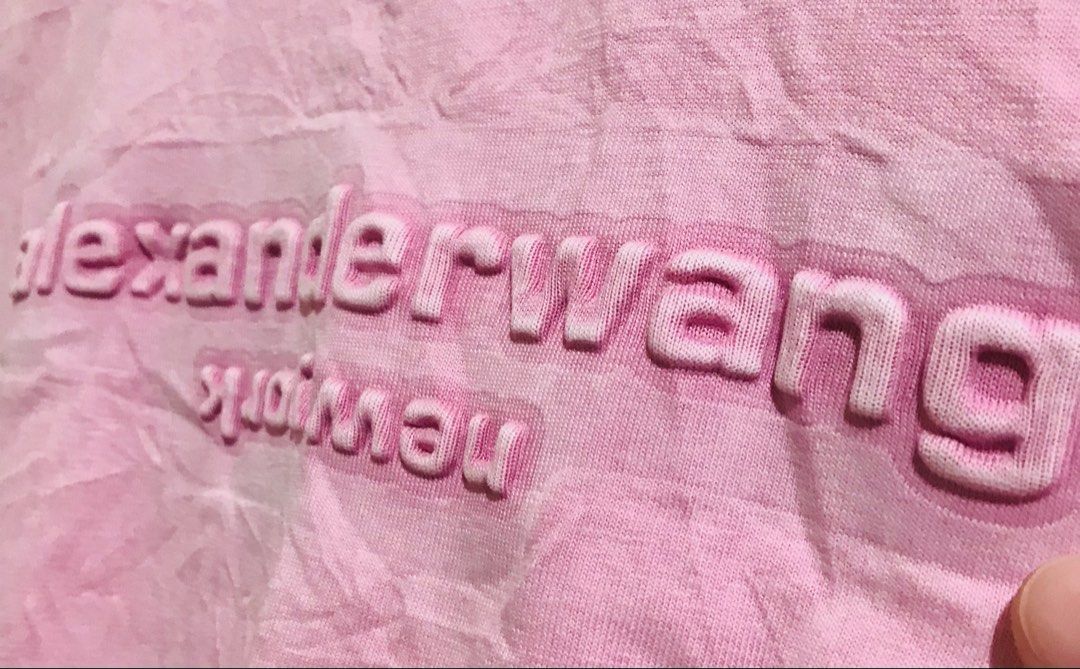 Alexander Wang Pink Debossed Logo T-shirt (Category: Luxury Apparel) located in Manila. Submitted by luxurybrandedthrift05 (Listing ID 1470213193, Image 3). Description: - Brand: Alexander Wang - Item: Debossed Logo T-Shirt - Color: Pink with contrasting tone logo - Size: M - Material: Soft cotton blend with a great handfeel - Design: Raised debossed "alexanderwang new york" lettering on chest, short sleeves, crew neckline - Details: Includes ori