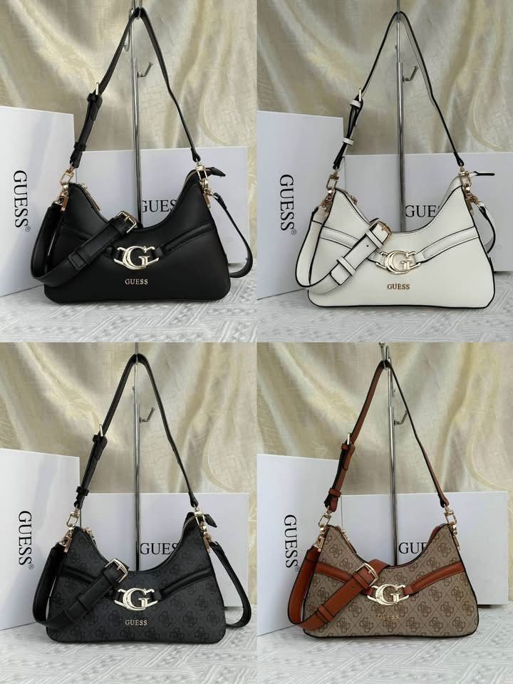 [ALL COLORS] GUESS Dea Shoulder Bag (Category: Shoulder Bags) located in Abucay. Submitted by erindeclutterss (Listing ID 1470349012, Image 1). Description: - Brand: GUESS - Available Colors: Black, White, Black Monogram, Brown Monogram - Features: Adjustable strap, gold-tone metal G logo buckle, and zip top closure - Design: Trendy structured slouchy shape - Packaging: Includes branded white box - Condition: Brand new and high quality - Size: 9 