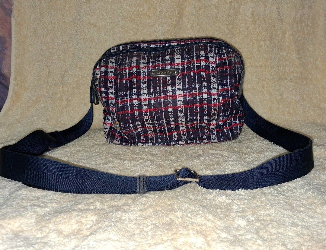 All For You Crossbody Bag Plaid Pattern (Category: Cross-body Bags) located in Angeles City. Submitted by anneps (Listing ID 1470219372, Image 2). Description: - Stylish plaid crossbody bag in red, white, and navy blue - Multiple zippered compartments for easy organization - Dark blue adjustable shoulder strap for a custom fit - Elegant small metal brand plaque on the front - Durable interior with a trendy printed text pattern on black lining.