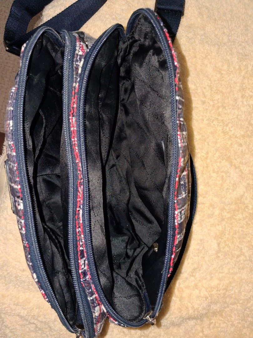 All For You Crossbody Bag Plaid Pattern (Category: Cross-body Bags) located in Angeles City. Submitted by anneps (Listing ID 1470219372, Image 3). Description: - Stylish plaid crossbody bag in red, white, and navy blue - Multiple zippered compartments for easy organization - Dark blue adjustable shoulder strap for a custom fit - Elegant small metal brand plaque on the front - Durable interior with a trendy printed text pattern on black lining.