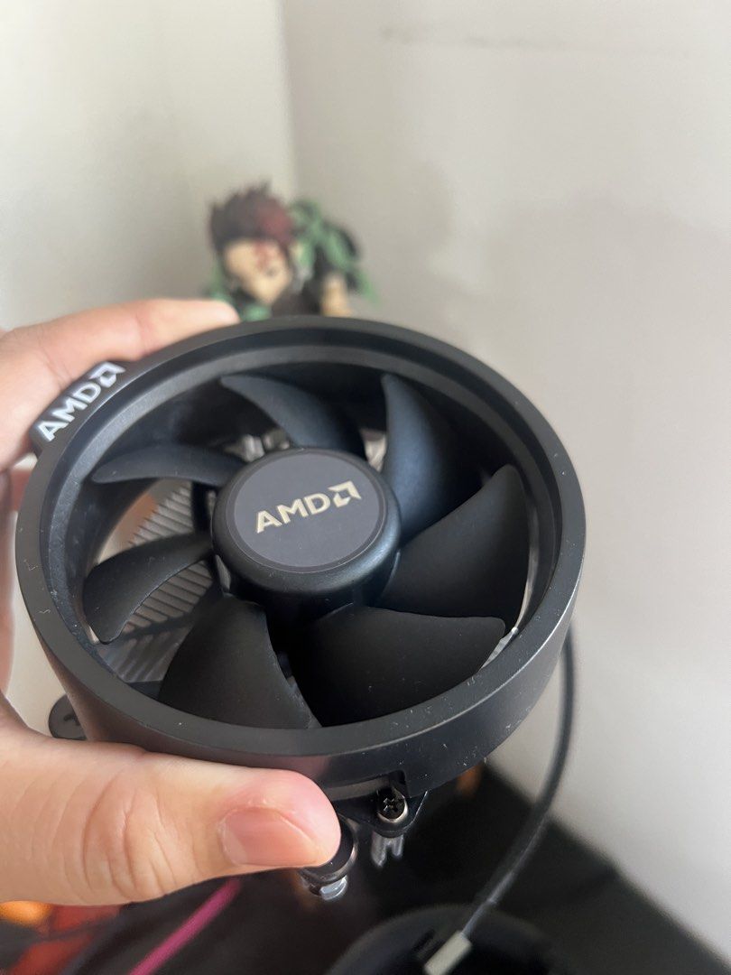 AMD Wraith CPU Cooler Stock Fan (Category: Computer Parts) located in Paombong. Submitted by declutteredbychee_ (Listing ID 1470232786, Image 1). Description: - Stock AMD CPU cooler (unused) - Standard aluminum heatsink with black fan shroud - Clean fins with no bent metal - Fully functional fan with standard 4-pin connector - Compatible with AMD AM4 and related sockets - Pre-installed mounting screws included for easy installation.