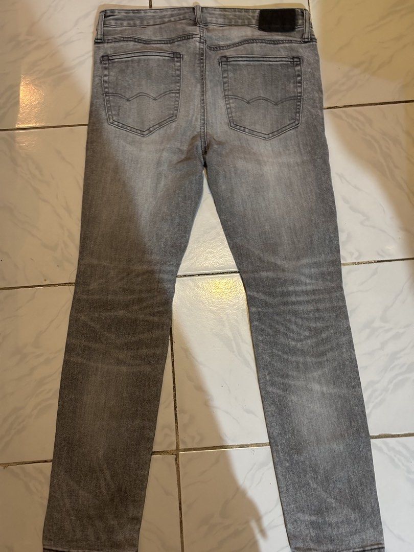 American Eagle Distressed Grey Jeans (Category: Jeans) located in Gumaca. Submitted by sensilog (Listing ID 1470277757, Image 3). Description: - Brand: American Eagle - Size: 31x30 - Fit: Slim fit - Color/Finish: Grey washed finish - Details: Distressed with rips at the knees and front panels - Features: Classic five-pocket setup with button and zip fly closure - Condition: Comfortable denim with plenty of wear left.