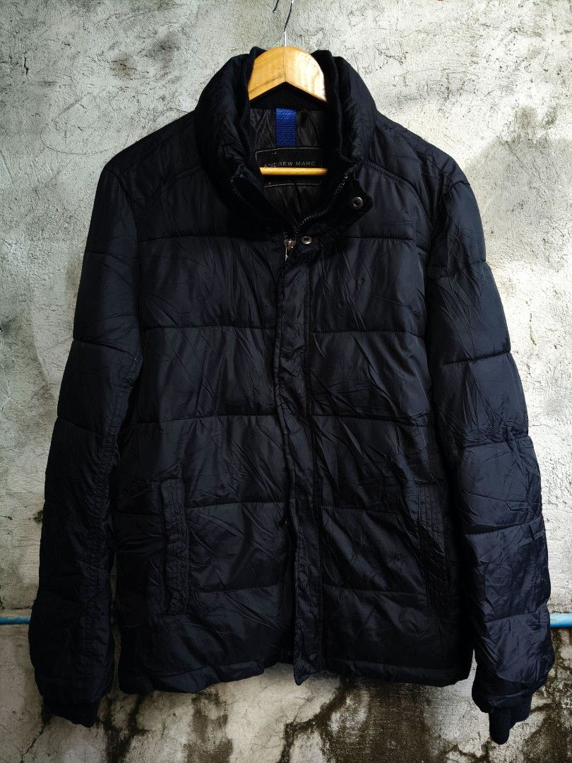 Andrew Marc Black Quilted Winter Puffer Jacket (Category: Coats, Jackets and Outerwear) located in Makati City. Submitted by theroadthrift (Listing ID 1470149285, Image 1). Description: - Brand: Andrew Marc - Color: Classic Black - Insulation: Thick quilted padding for maximum warmth - Closure: Full zip with snap button storm flap overlay - Design: High collar for wind protection and branded metal hardware - Cuffs: Ribbed inner cuffs to trap heat