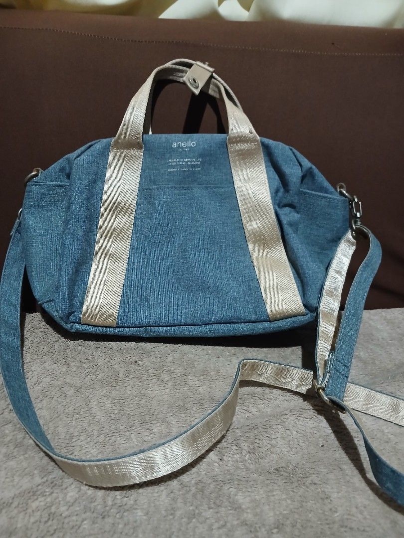 Anello Denim Blue Shoulder Handbag (Category: Shoulder Bags) located in Tanauan. Submitted by villegasmy47604 (Listing ID 1470240812, Image 2). Description: - Brand: Anello - Color: Denim blue with beige webbed handles - Includes: Matching detachable strap - Closure: Secure zipper top - Compartments: 1 inner zipped compartment and open pocket slots - Style: Casual, ideal for everyday use - Condition: Hardware shows slight signs of wear around the