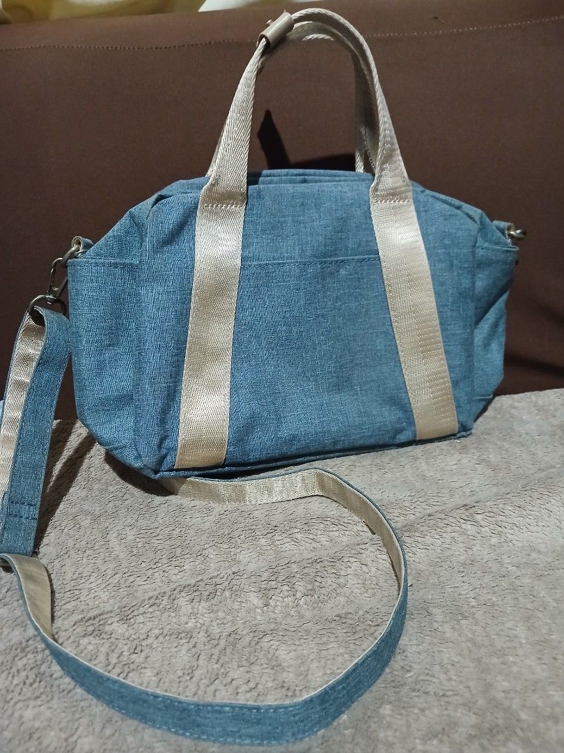 Anello Denim Blue Shoulder Handbag (Category: Shoulder Bags) located in Tanauan. Submitted by villegasmy47604 (Listing ID 1470240812, Image 3). Description: - Brand: Anello - Color: Denim blue with beige webbed handles - Includes: Matching detachable strap - Closure: Secure zipper top - Compartments: 1 inner zipped compartment and open pocket slots - Style: Casual, ideal for everyday use - Condition: Hardware shows slight signs of wear around the