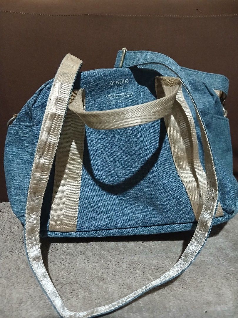 Anello Denim Blue Shoulder Handbag (Category: Shoulder Bags) located in Tanauan. Submitted by villegasmy47604 (Listing ID 1470240812, Image 1). Description: - Brand: Anello - Color: Denim blue with beige webbed handles - Includes: Matching detachable strap - Closure: Secure zipper top - Compartments: 1 inner zipped compartment and open pocket slots - Style: Casual, ideal for everyday use - Condition: Hardware shows slight signs of wear around the
