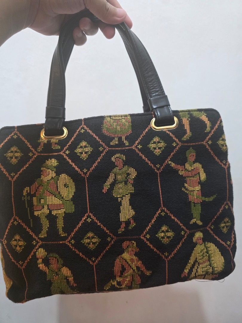 Anice Aria Italy Tapestry Handbag (Category: Purses & Pouches) located in Manila. Submitted by littleclosetfindsmnl (Listing ID 1470172414, Image 3). Description: - Anice Aria Italy Vintage Tapestry Handbag - Black woven fabric with medieval-inspired tapestry pattern - Solid black leather handles and matching brand tag - Gold-tone hardware - Zippered main closure with fabric-lined interior - One exterior back zip pocket and one inner pocket - Pre