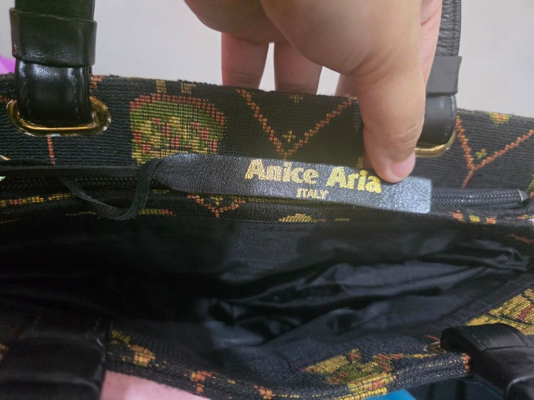 Anice Aria Italy Tapestry Handbag (Category: Purses & Pouches) located in Manila. Submitted by littleclosetfindsmnl (Listing ID 1470172414, Image 2). Description: - Anice Aria Italy Vintage Tapestry Handbag - Black woven fabric with medieval-inspired tapestry pattern - Solid black leather handles and matching brand tag - Gold-tone hardware - Zippered main closure with fabric-lined interior - One exterior back zip pocket and one inner pocket - Pre
