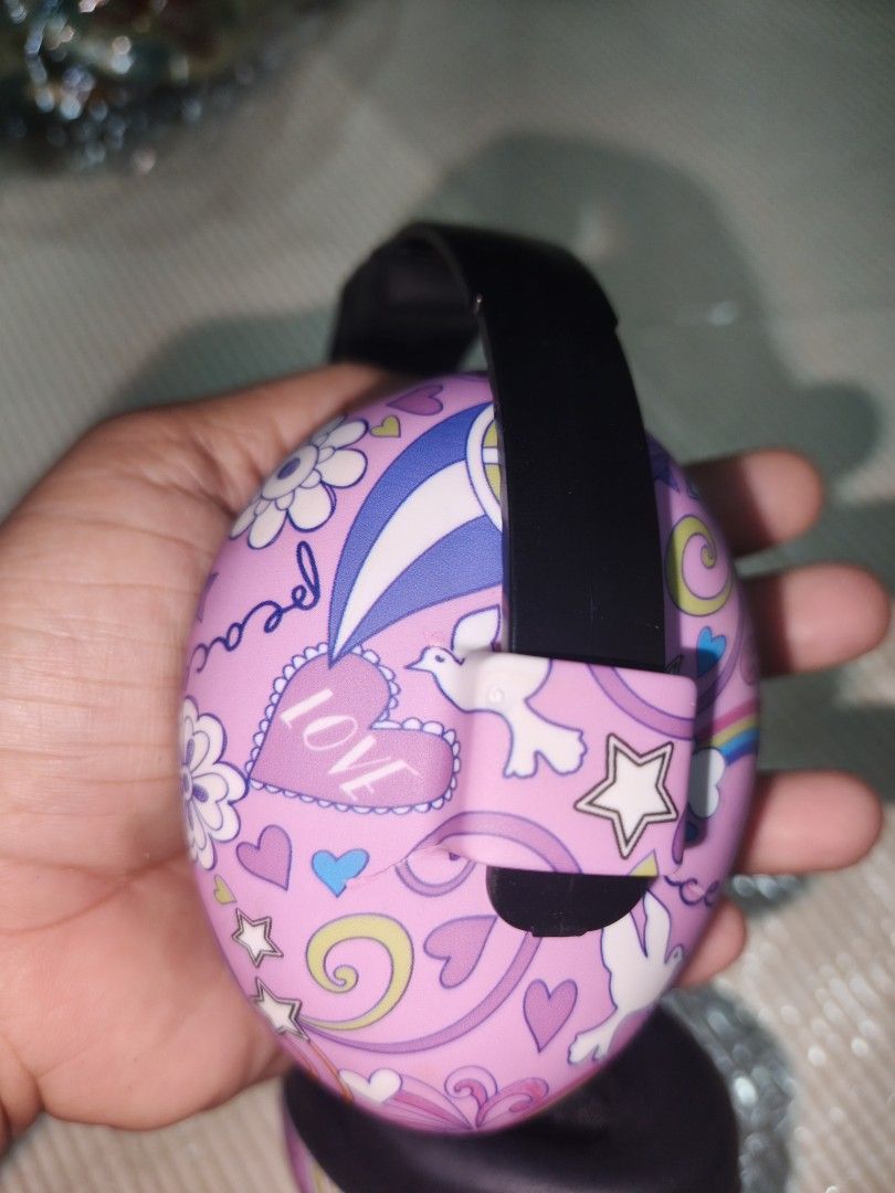 ANZ Kids Earmuffs Pink Rainbow Pattern (Category: Babies & Kids Fashion) located in Manila. Submitted by reascheyss51406 (Listing ID 1470154672, Image 2). Description: - Brand/Model: ANZ Kids Earmuffs - Color/Design: Pink with a colorful rainbow, star, and cloud pattern - Comfort: Soft cushioning on the ear pieces and headband segments - Headband: Black padded band featuring the ANZ logo - Fit: Fully adjustable sizing on both sides to grow with y
