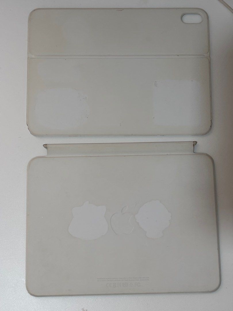 Apple Magic Keyboard Folio for iPad 10th Gen (Category: Cases & Sleeves) located in Taguig. Submitted by chewiechuchu (Listing ID 1470223663, Image 3). Description: - Authentic and original Apple Keyboard Folio for iPad 10th generation in white - Magnetic and detachable design - Keys and trackpad are 100% functional and intact - Note: Shows visible discoloration, dirt, stains, and sticker marks on the outer surfaces from daily use (priced accordi