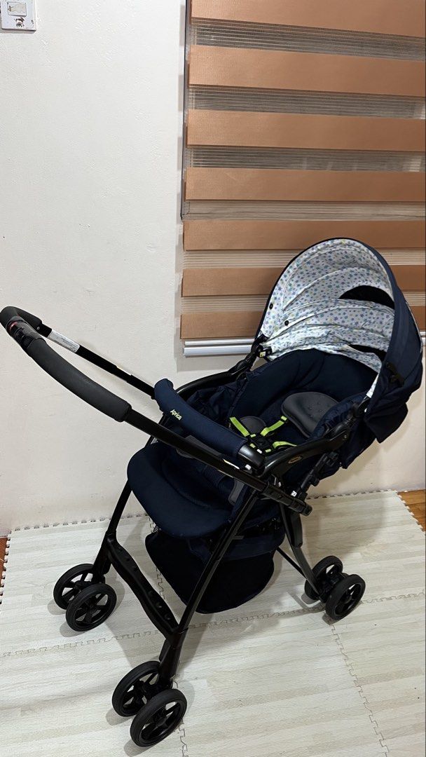 Aprica karoon high plus starry night Canopy (Category: Strollers) located in Santa Rosa. Submitted by mommy.cole.affordable.stuff (Listing ID 1470231059, Image 1). Description: - Brand: Aprica - Color: Navy blue with cute star-patterned canopy lining - Handle: Reversible setup - Comfort: Multi-position recline with padded head support and harness straps - Wheels & Frame: Large wheels and solid black frame for a smooth ride - Storage: Convenient m