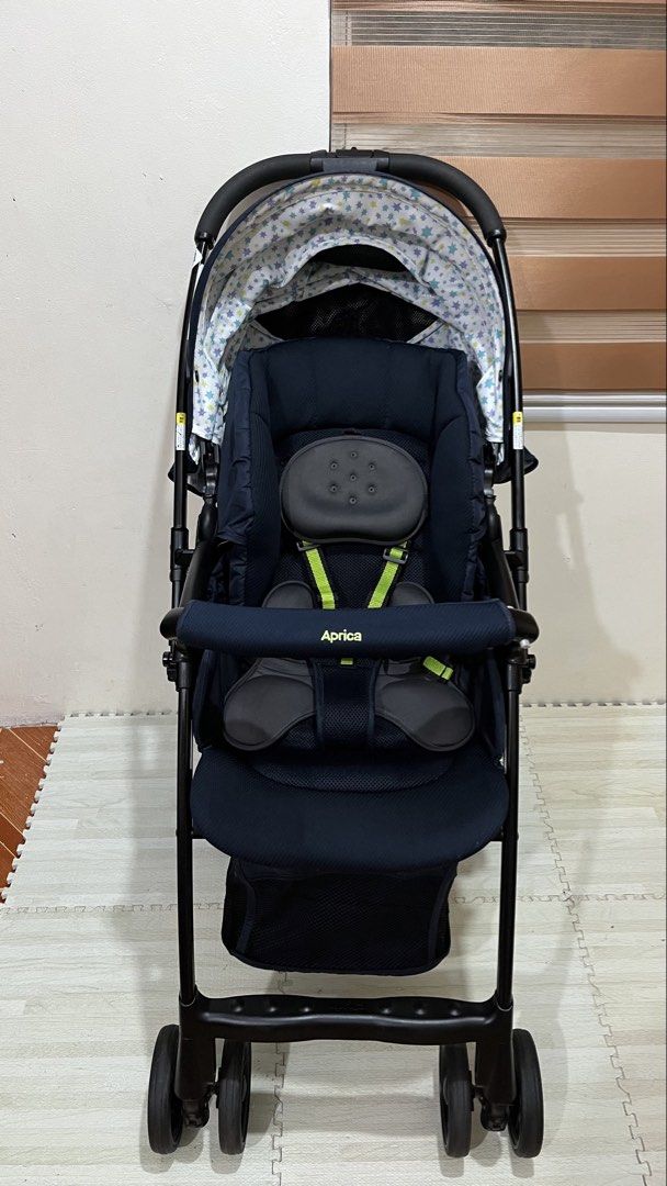 Aprica karoon high plus starry night Canopy (Category: Strollers) located in Santa Rosa. Submitted by mommy.cole.affordable.stuff (Listing ID 1470231059, Image 3). Description: - Brand: Aprica - Color: Navy blue with cute star-patterned canopy lining - Handle: Reversible setup - Comfort: Multi-position recline with padded head support and harness straps - Wheels & Frame: Large wheels and solid black frame for a smooth ride - Storage: Convenient m