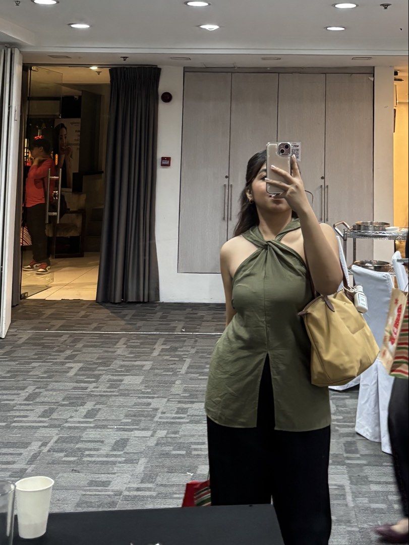 Army Green Halter Neck Top With Shoulder Straps (Category: Sleeveless) located in Manila. Submitted by atinuuuh (Listing ID 1470208669, Image 2). Description: - Color: Army Green / Neutral earth tone - Style: Halter neck top with two tied shoulder straps at the back - Detail: Slight split hem at the bottom front - Fabric: Lightweight and textured - Pairing: Easy to style with high-waisted pants or skirts for casual days out.