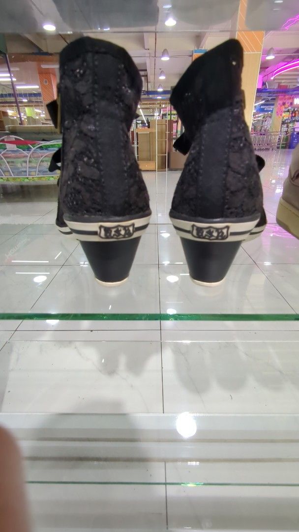 Ash Wedges Lacey Black Sneakers (Category: Sneakers) located in Cavite. Submitted by chocomint.bb (Listing ID 1470309515, Image 2). Description: - Size: 37 (marked clearly on inner sole) - Style: High-top wedge sneakers with extra height - Color/Material: Black patterned fabric upper with rubber toe caps - Details: Chunky ribbon laces and standard lace detailing - Hardware: Chic gold-tone eyelets and convenient side zippers.