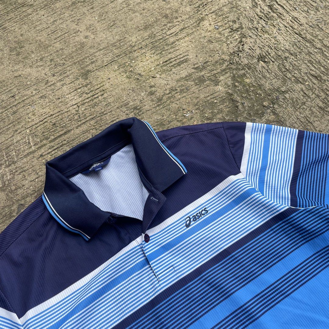Asics Blue Striped Polo Shirt (Category: Tshirts & Polo Shirts ) located in Manila. Submitted by lawlaw21 (Listing ID 1470177930, Image 2). Description: - Brand: Asics - Color: Navy blue and bright blue with horizontal stripes - Size: 100 - Features: Polo collar, single button placket, lightweight athletic fabric - Perfect for active wear or smart-casual looks.