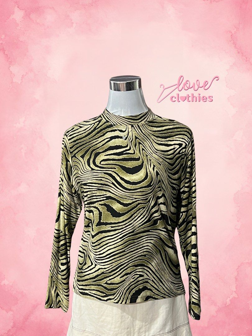 Assemblage Zebra Print Mock Neck Long Sleeve Top (Category: Longsleeves) located in Tuguegarao City. Submitted by love_clothies (Listing ID 1470319483, Image 1). Description: - Brand: Assemblage - Design: Green and black zebra animal pattern - Style: Mock neck, long sleeve top - Material: 90% polyester, 10% polyurethane (stretchy & lightweight) - Origin: Made in China - Care: Hand wash only at 30°C - Size: S-M.