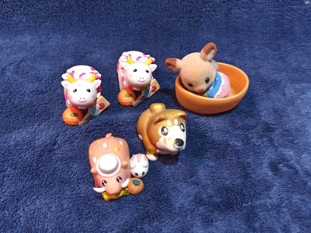 Assorted Cute Animal Figurines and Toys Bundle (Category: Designer & Blind Box Toys) located in Manila. Submitted by kirstentoyshub (Listing ID 1470246807, Image 2). Description: - Adorable mini animal figurine bundle - Includes: 2 white cows with oranges, 1 pink pig with companion, 1 golden dog, and 1 fuzzy rabbit in an orange bowl - Colors: White, pink, gold, and orange - Perfect for miniature collectors or cute desk display - Sold as a set (al